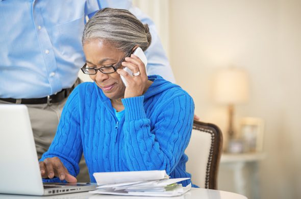 Port's Heating & Air | Older woman looking at laptop and making a phone call