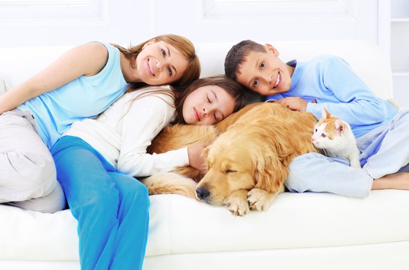 Port's Heating & Air | Children sitting comfortably on couch with their pets